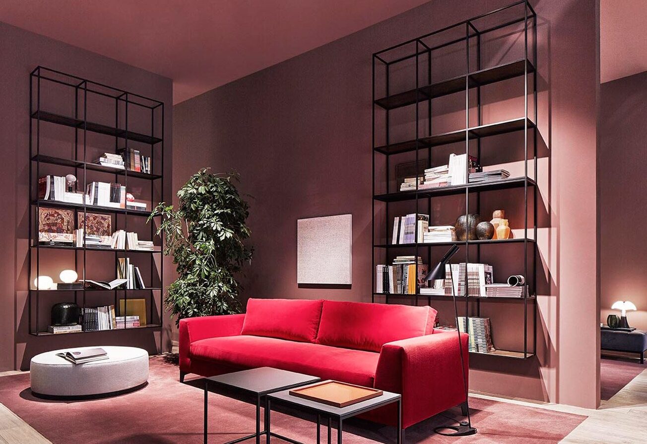 red velvet sofa and shelves behind