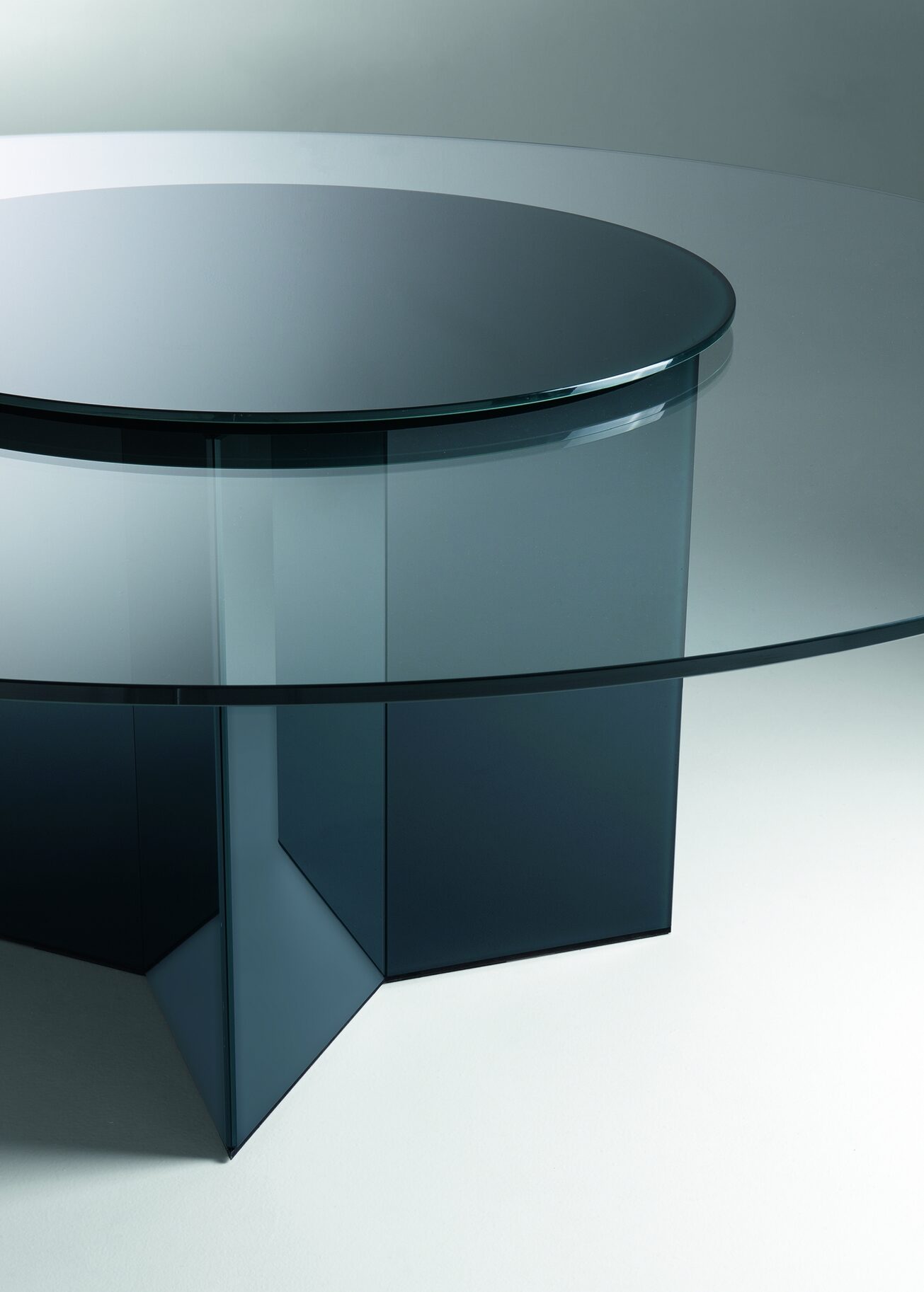 circular glass table top with a striking base